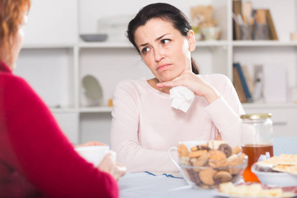 istock Unhappy female talking with mother at table 916564046