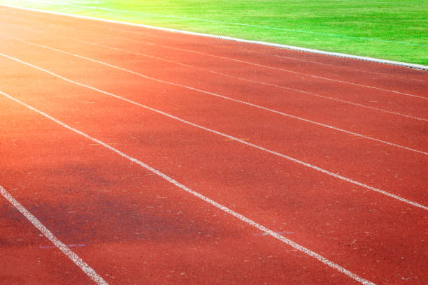 istock Red running track, white line in the stadium 916564444