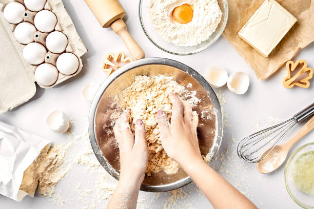 istock Baker preparing to knead the dough, top view. Cooking, bakery concept 916568436