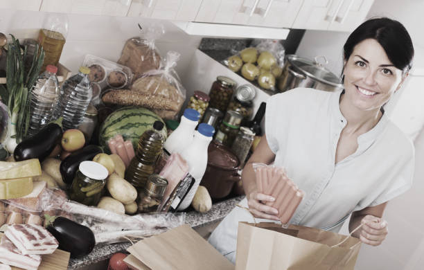 istock Woman with sausages in kitchen 916568714