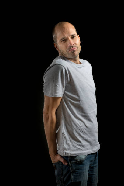 istock man looking at camera with his hands in his pockets 916571190