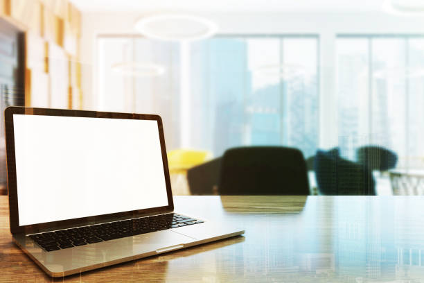 istock White screen laptop on an office table side toned 916586844