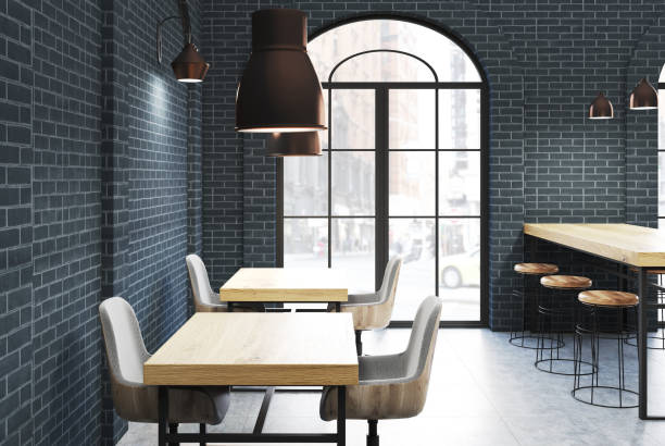 istock Black brick cafe, wooden tables side 916590980