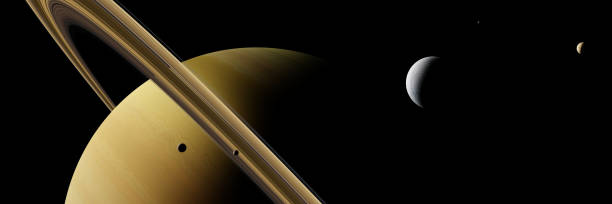istock planet Saturn with moon Enceladus and other moons 916592146