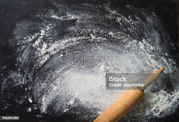Baking Background With The Rolling Pin And Flour On The Dark Table Stock Photo - Download Image Now