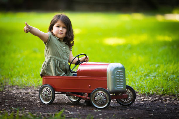 istock Little cuban girl driving car 916599250