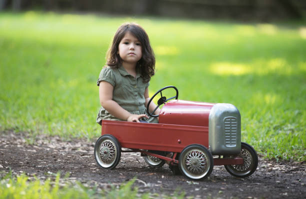 istock Little cuban girl driving car 916599646