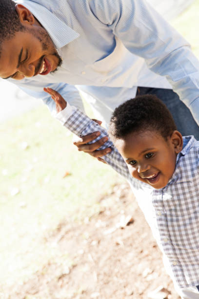 istock Father and son play at the park together. 916602736