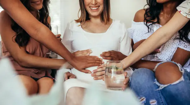 Photo of Friends sharing positivity and care for pregnancy