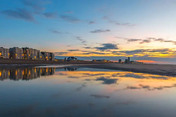 The skyline of the North Sea beach of Ostend city at sunset, West Flanders, Belgium.