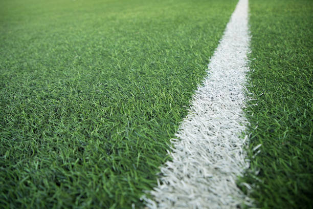 istock white stripe line on green soccer pitch 916607580