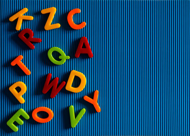 Colorful plastic alphabet letters on a blue