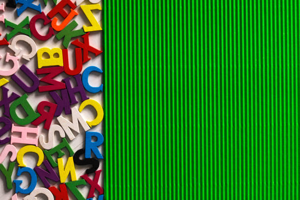Colorful wood alphabet letters on a green