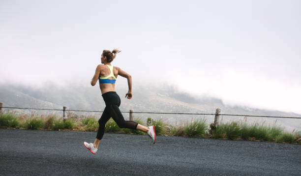 istock Woman athletes running on road 916610838