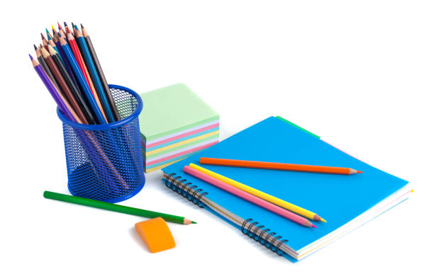 istock colored pencils in the basket, Eraser and notebook on white background 916610852