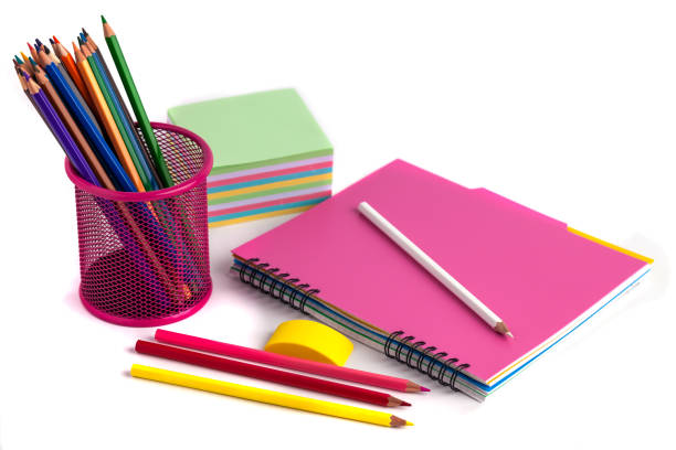 istock colored pencils in the basket, Eraser and notebook on white background 916610978