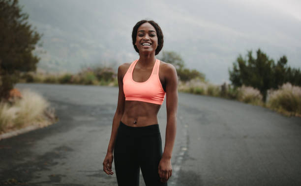 istock Young woman athlete on road 916611104