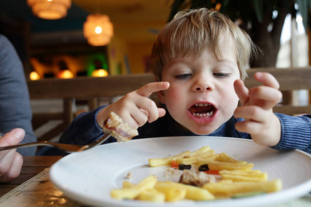 istock Boy eating french fries 916611434
