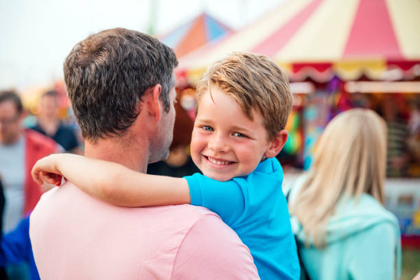 istock Little Boy with his Dad at an Amusement Park 916613770