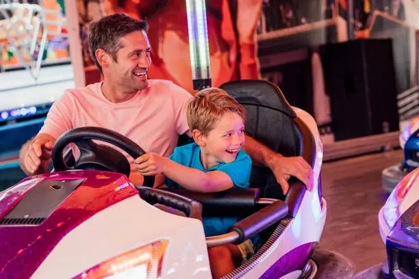 Photo of Father and Son Driving Dodgem Cars