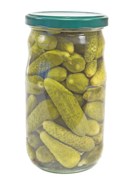 istock Pickled cucumbers in glass jar isplated on white 916617860
