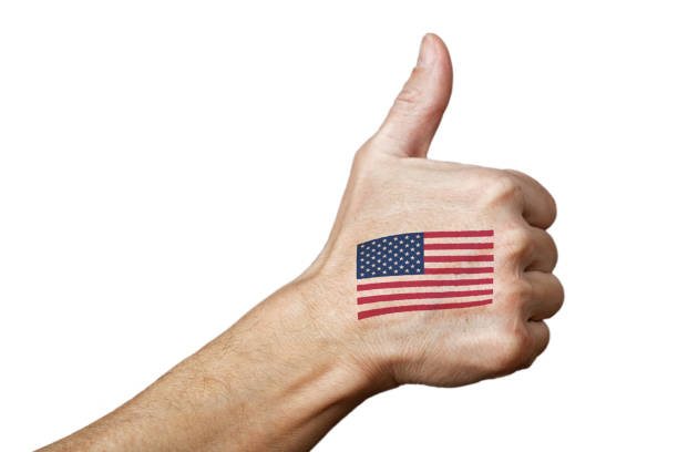 Human hand with a painted or tattooed American flag showing thumb up sign. Isolated on white.