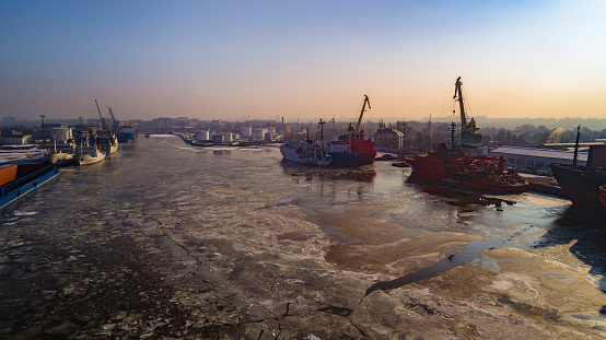 Aerial view on the commercial docks in the North Port on the frozen river. Kaliningrad, Russia.