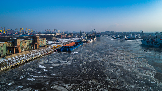 Aerial view on the commercial docks in the North Port on the frozen river. Kaliningrad, Russia.