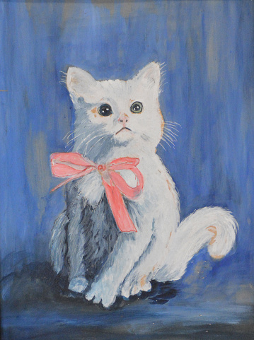 A portrait of a small white kitten with a pink bow.