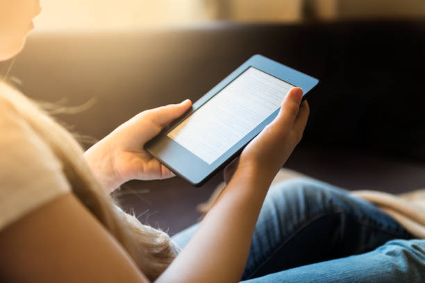 istock Girl is reading ebook on digital tablet device 916625560