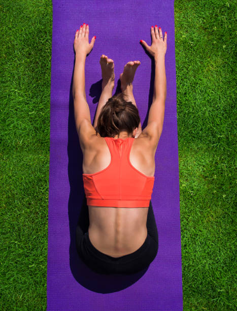 istock Young girl doing yoga in the park 916628732