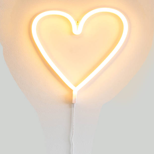 istock Heart shaped neon light valentine background texture 916628930