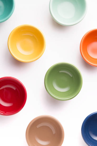 istock Pattern of small colorful bowls on a white background viewed from above. Top view. 916629684