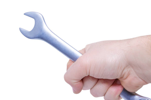 istock Man's hand holds a wrench isolated on white background. Close up. High resolution product 916630278