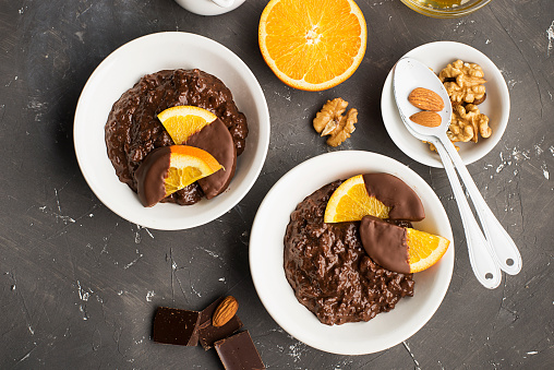 Chocolate rice pudding porridge risotto with oranges in chocolate for breakfast. Top view.