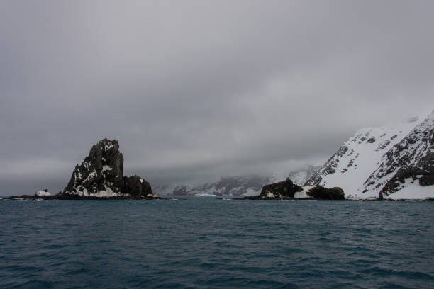 istock Rock with snow in sea 916635872