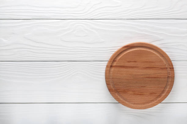 istock empty wooden cutting board on a light wooden background 916635986