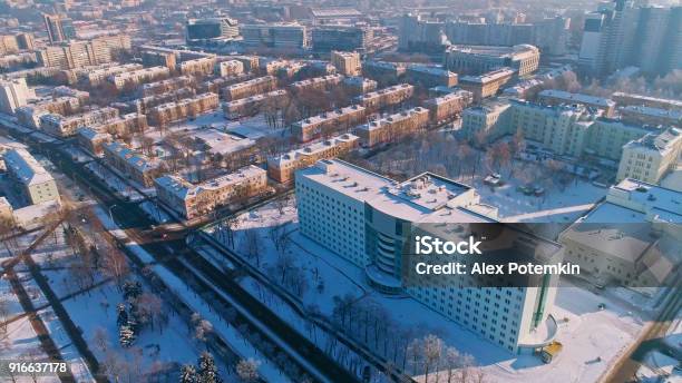 The Aerial Panoramic View On The Winter City Covered By The Snow In The Bright Cold Sunny Day Orbit Camera Motion Stock Photo - Download Image Now