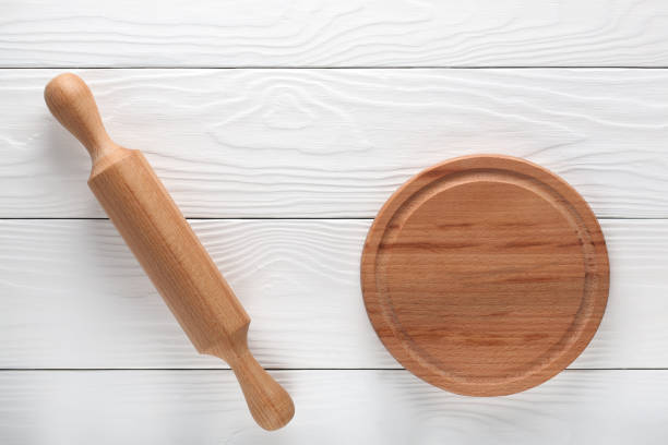 istock empty wooden cutting board and rolling pin on a light wooden background 916639506