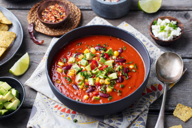 istock Mexican tomato, bean, bell pepper soup in black bowl. 916644112