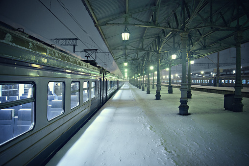 Night view of the station platforms at snowy cold winter time.