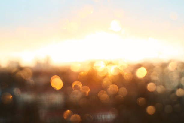 istock Rain drops texture on window glass with gorgeous vintage orange amber sunset light abstract blurred cityscape skyline bokeh background. Soft focus. 916646402