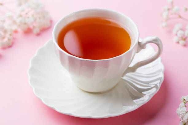 istock Cup of tea with fresh flowers on pink background. 916646442