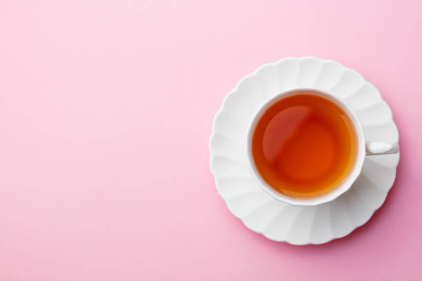 Cup of tea on pink background. Top view. Copy space