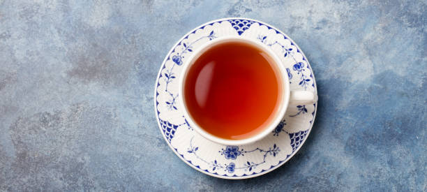 istock Cup of tea on a blue stone background. Copy space. Top view 916646532