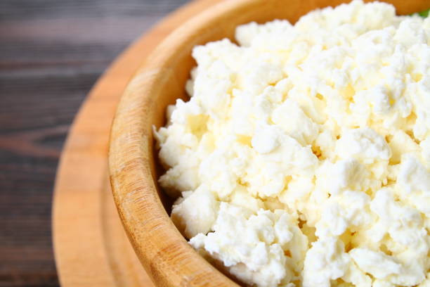 istock Home cottage cheese in a bowl on a wooden table. 916646732
