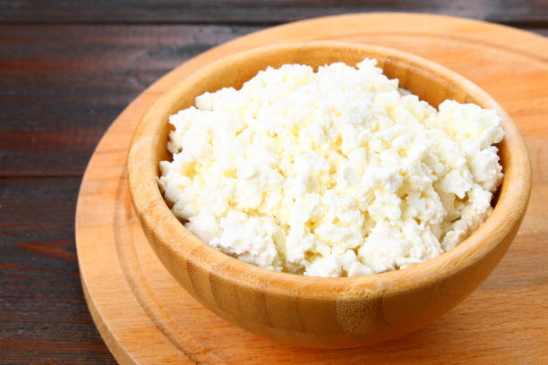 istock Home cottage cheese in a bowl on a wooden table. 916646740