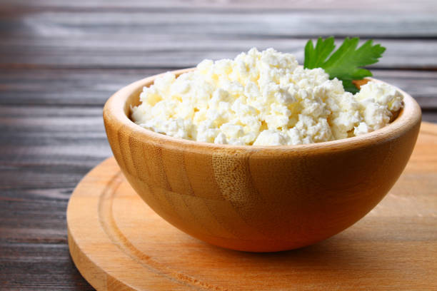 istock Home cottage cheese in a bowl on a wooden table. 916646752
