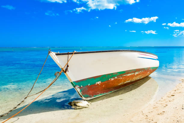 Old wooden boat on the shore of Indian ocean stock photo