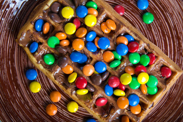 istock Plate of belgian waffles with colored candy 916657110
